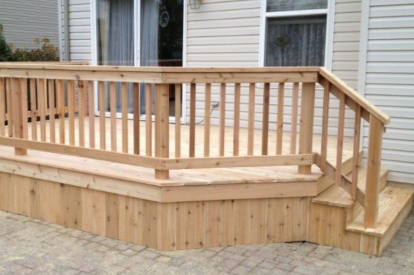 Custom cedar deck with railings and paver patio