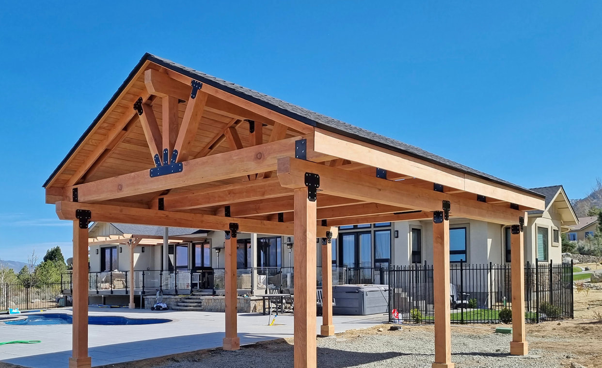 Timber-framed covered pavilion over a pool with hot tub